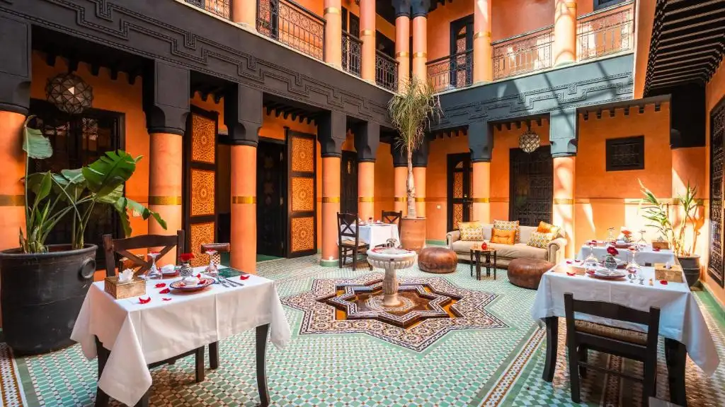 Traditional riad courtyard in Marrakech Medina with Moroccan architecture, fountain, and garden